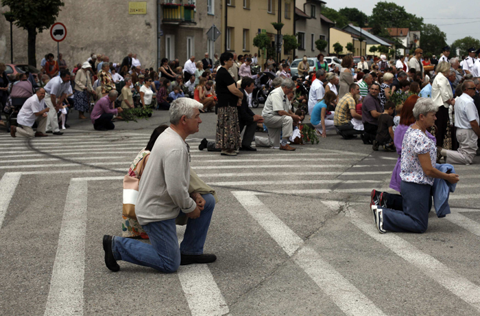 People kneel on the street as they take part in a Corpus Christi procession (Kacper Pempel, 2013, Gora Kalwaria, Poland, © CNS photo/Kacper Pempel, Reuters)